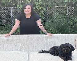She is an animal lover and has adopted a cute black dog in her home.